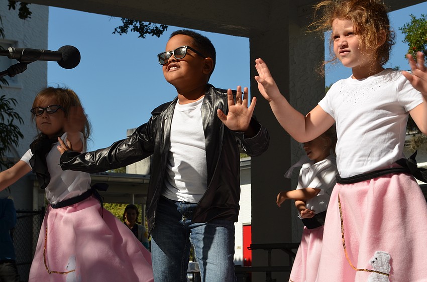 Students dressed in poodle skirts and leather jackets perform to the Elvis hit 