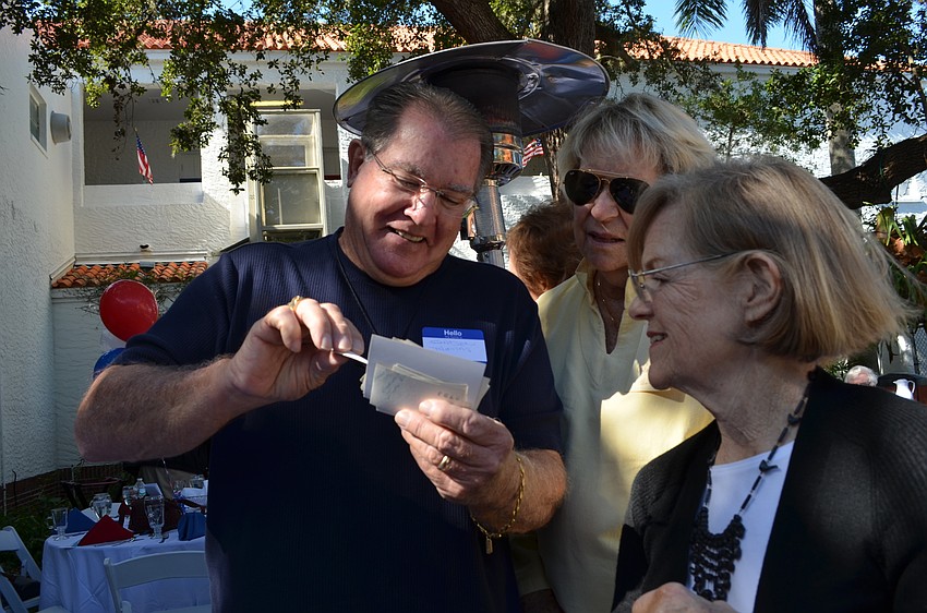 Former classmates Gaden Thomas, Pam Wyatt and Ann Darling catch up over old photos.
