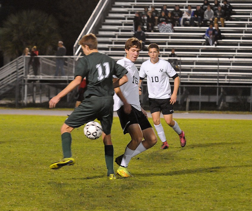 Lakewood Ranch defender Trevor Franko attempts to regain possession from Venice's John Ireland.