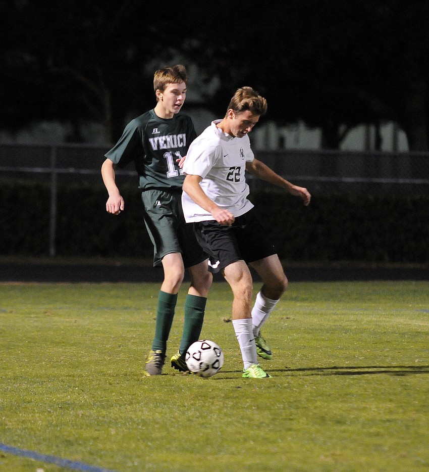 Lakewood Ranch senior defender Connor Hetterich battles Venice's John Ireland for possession early in the first half.