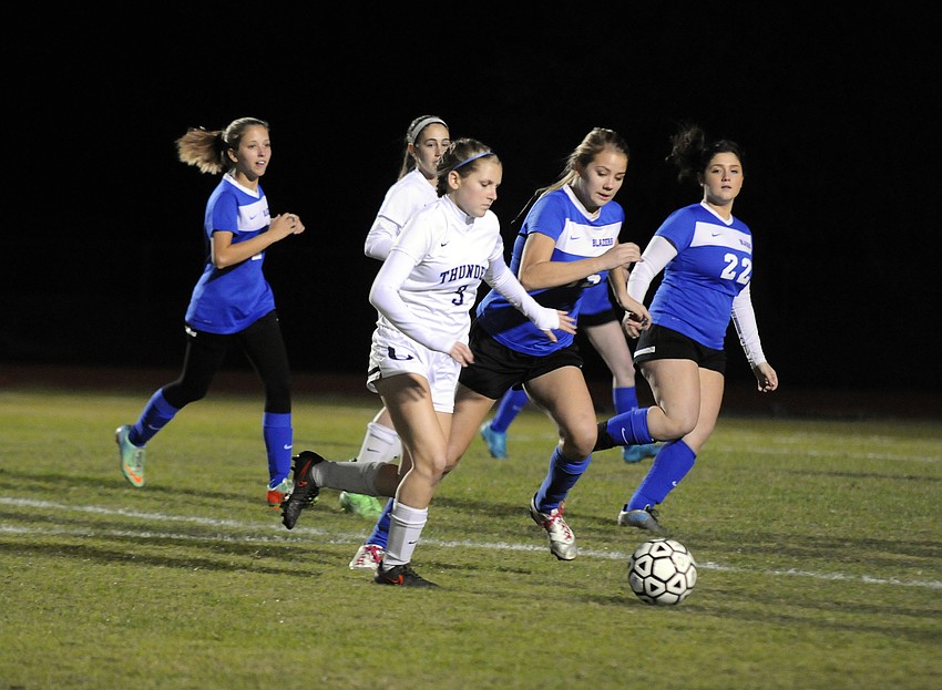ODA's Chloe Flanders dribbles the ball down the field against Sarasota Christian's Michelle Gallatin and Mara Baran.