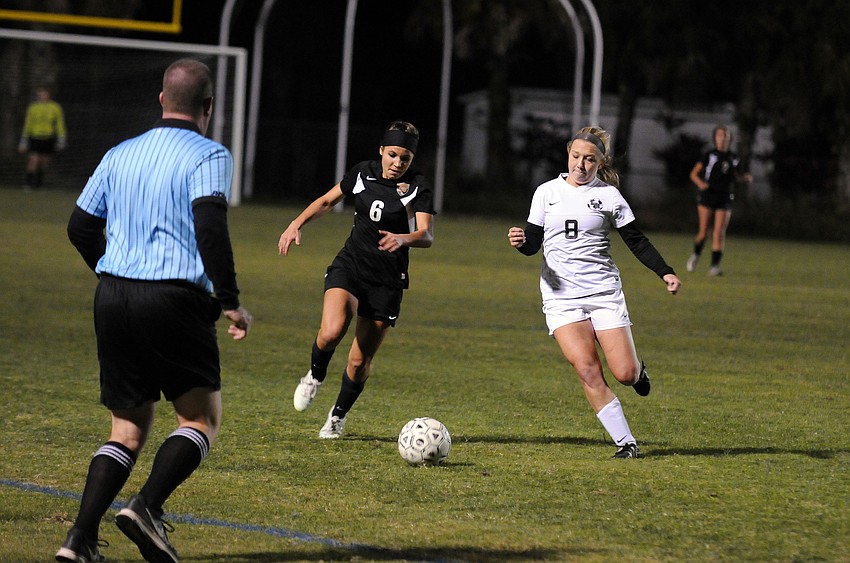 Sarasota's Elizabeth Giuffre attempts to maneuver the ball past Lakewood Ranch's Sydney Wicks.