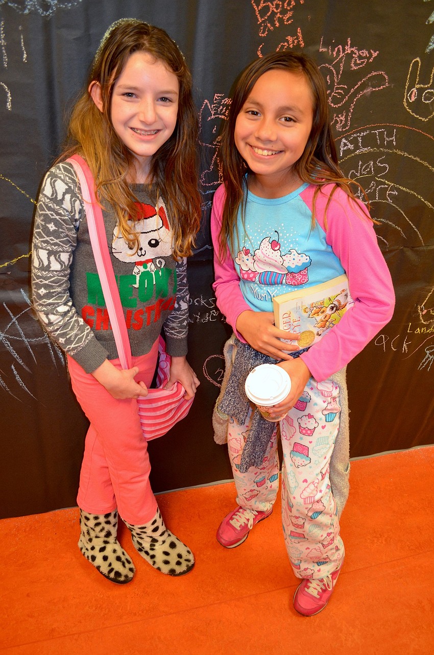 Emily Ellis and Lindsay Page show off colorful pajamas.