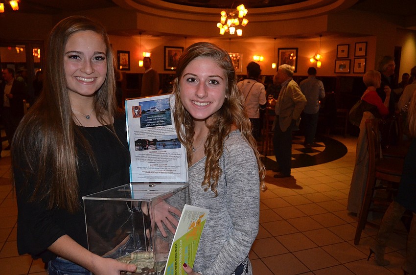 Lakewood Ranch High students Ally Boudreau and Noelle Kourakos collect entries for the raffle. The grand prize is a cruise.