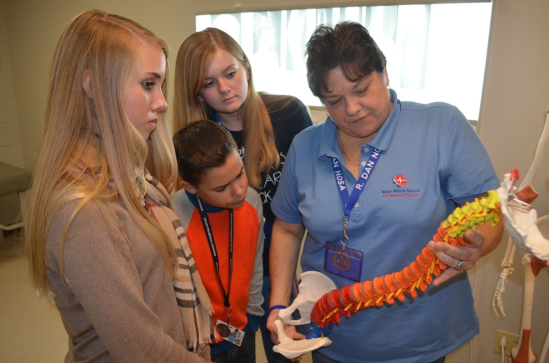 Anneliese Pruim, Elliot Santaella and Phoebe Bond-Abraham learn about the spine.
