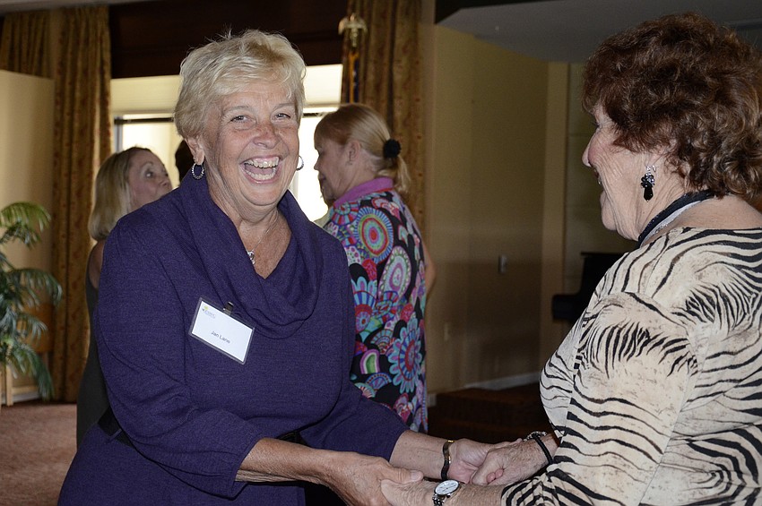 Jane Lane and Evonne Collins try to dance salsa together.