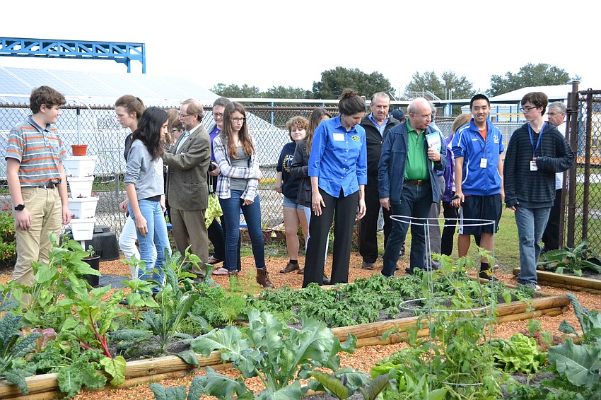 NASA scientists take a tour of the garden at Pine View School that is using the same fertilizer that is being used on the International Space Station.