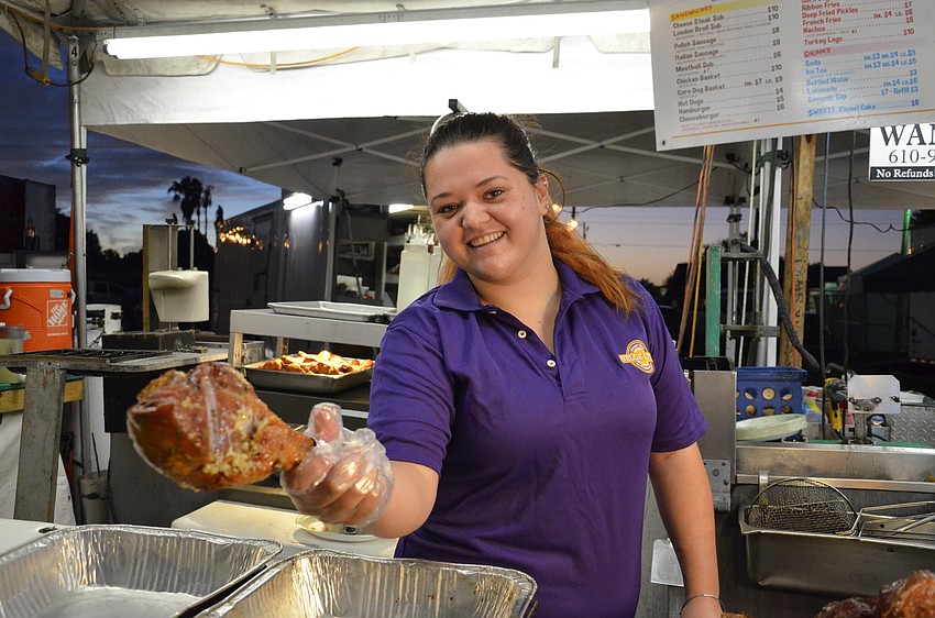 Chelsea Bianco serves up a turkey leg at her family's food stand.