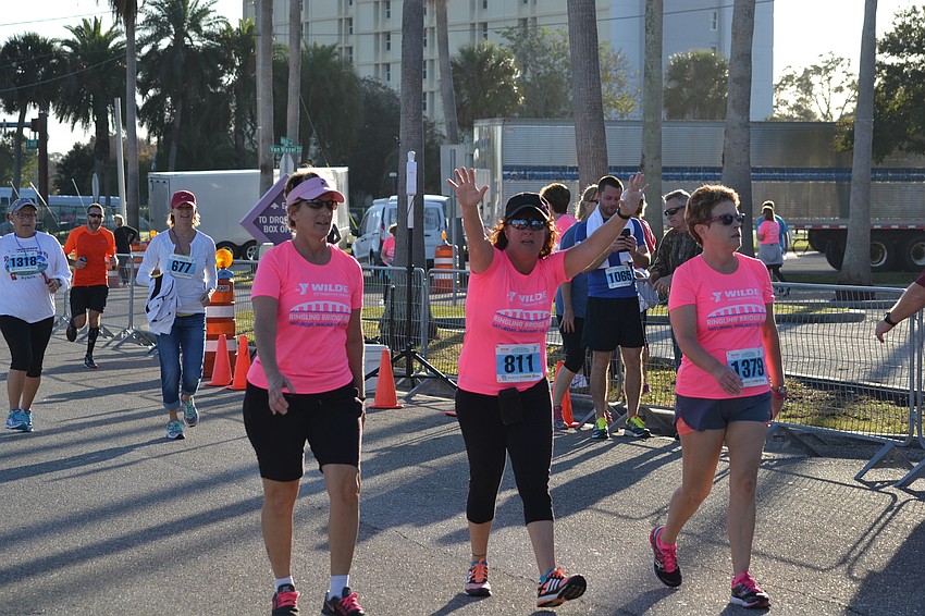 Pals Ali Samona, Lisa Galvin and Michelle Punshon celebrate before crossing the finish line.