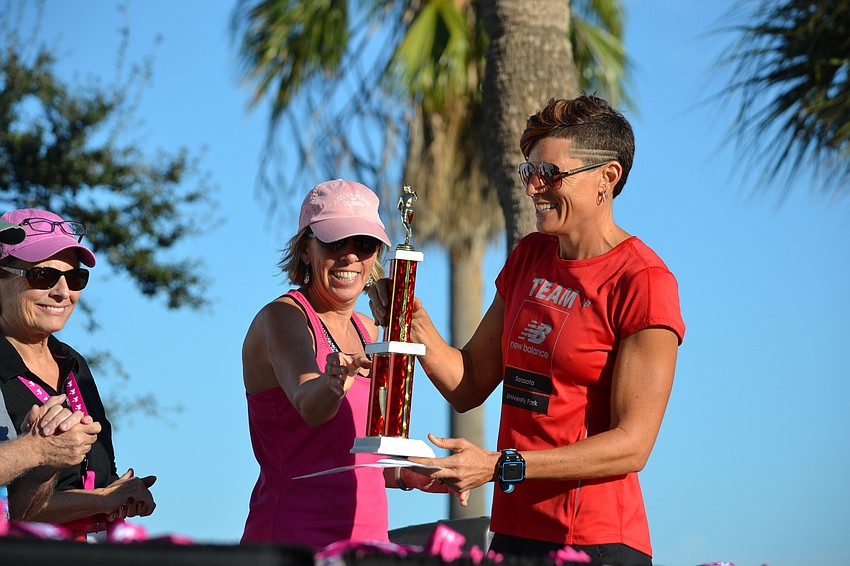 Overall female winner Heather Butcher returns to the winner's stand.