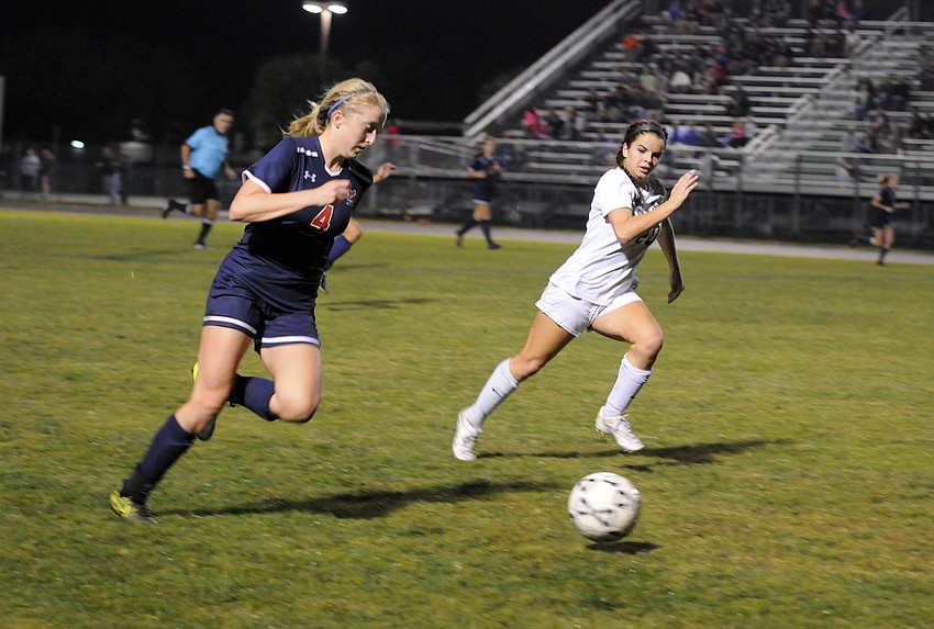 Lakewood Ranch junior defender Makenzie Fischer chases down Manatee's Jessica Schafer in the second half.