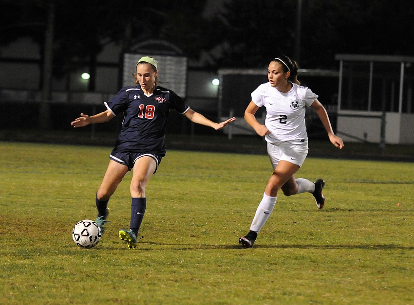 Lakewood Ranch sophomore forward Faith Schyck attempts to keep Manatee's Tyler Einsmann from passing the ball.