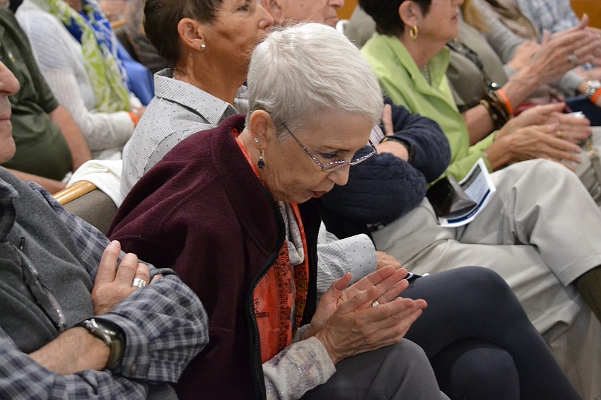 Temple Emanu-El member Linda Joffe sings along during the performance.