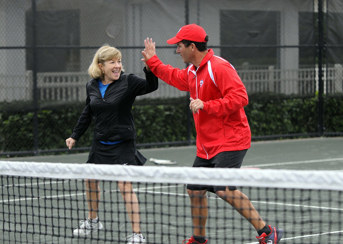 Sarasota resident Susan Beane and Stoneybrook tennis professional Andrew Sirota couldn't stop smiling during their warmup.