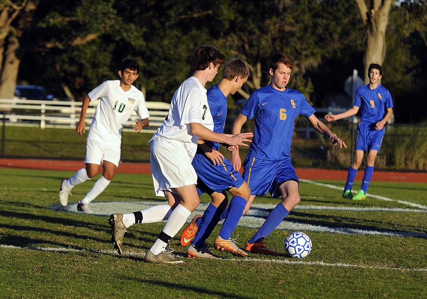 Sarasota Christian's Trey Lantz and Riley Hagan attempt to push the ball past St. Stephen's Nathan Thornton.