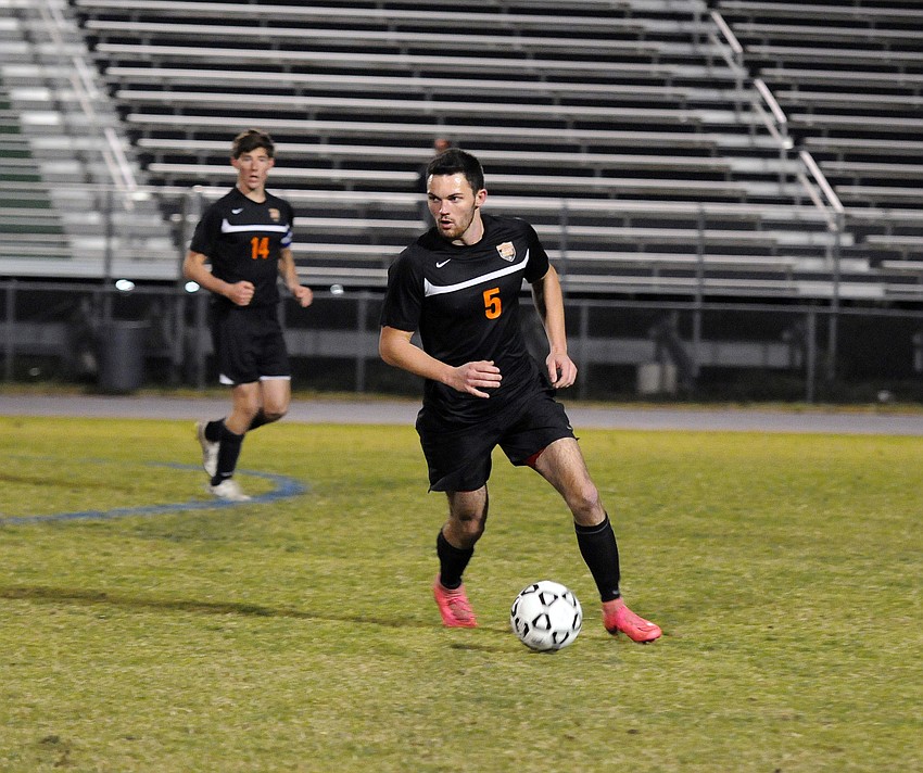 Sarasota senior Mitch Ward dribbles the ball across the midfield in the first half.