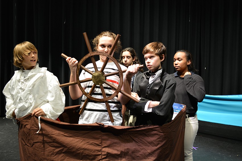 Prince Eric (Phineas Scanlon) argues with Grimsley (Caden Denslow), front right, as Olivia Knego steers the ship.