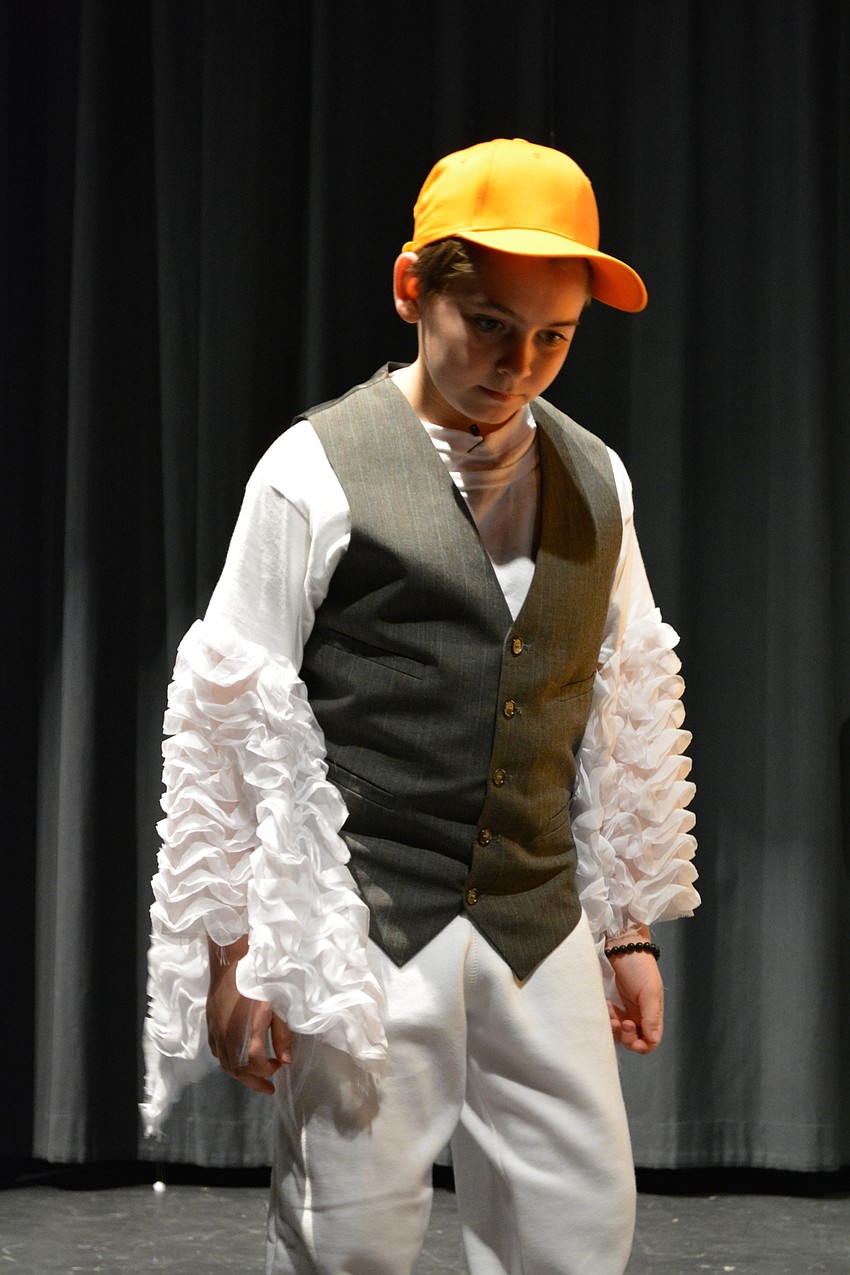 Ryan Newhams, as Scuttle, kicks the prince to make sure he is alive after washing up on shore.