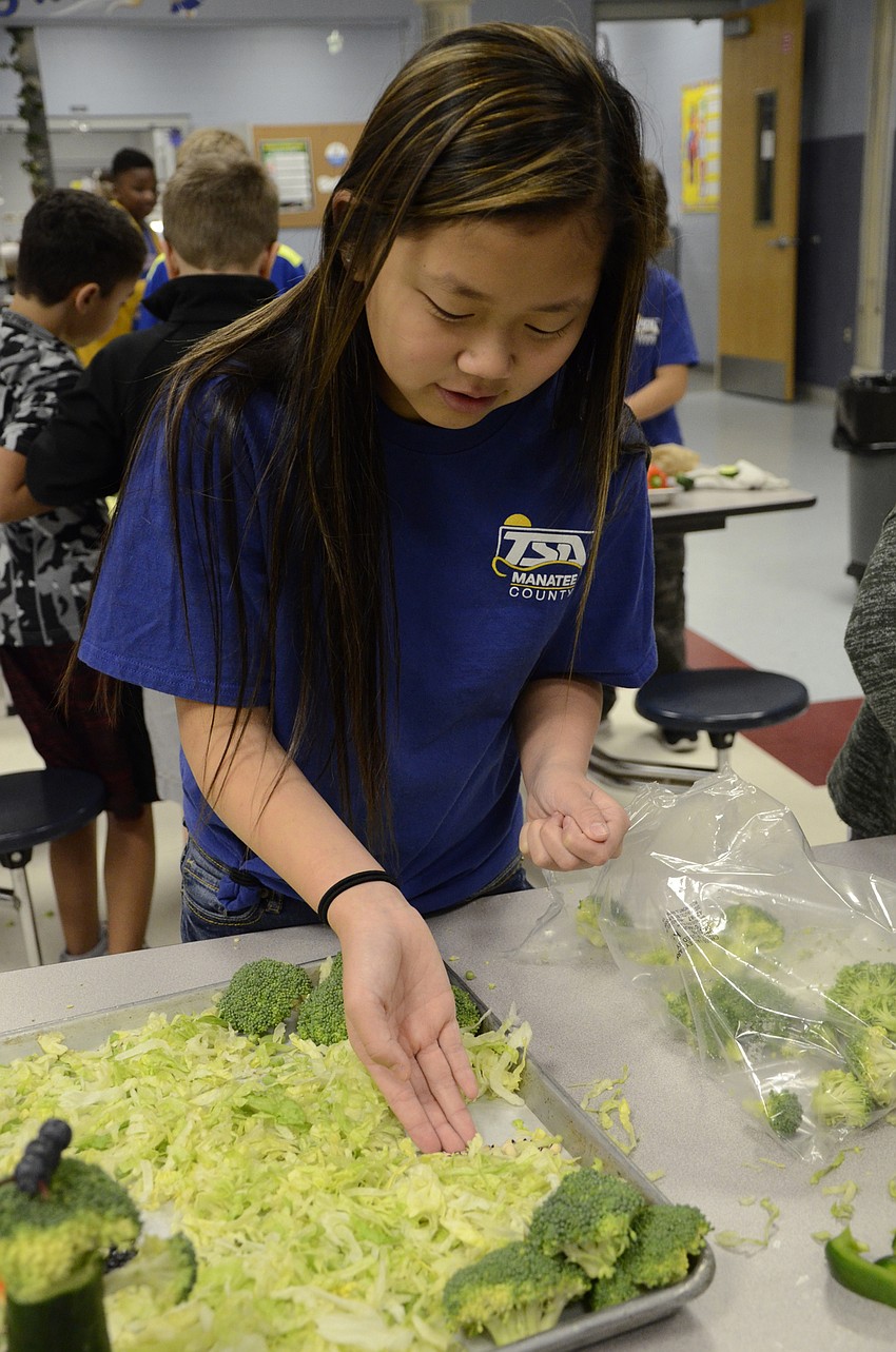 Chia Dobbelaire spreads some beans to make a rocky area in the winning design, 