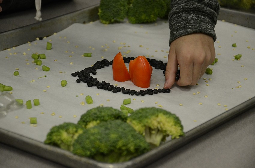 Red bell pepper slices and beans make up a campfire in 
