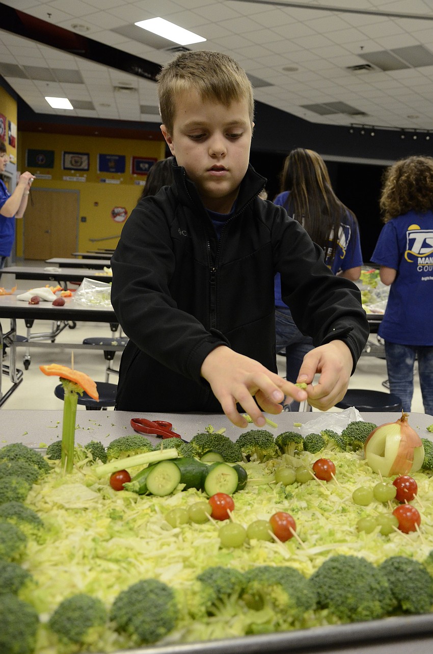 Ryan Gustafson spreads some lettuce 