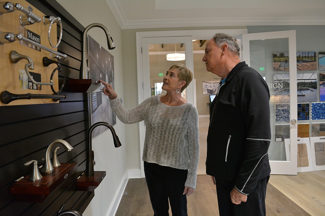 Joann and Steve Bishop look at the faucets they picked out for their new home in Del Webb at Lakewood Ranch. They couple visited the sales center over Christmas to try to meet their future neighbors â€”Â and, they did.