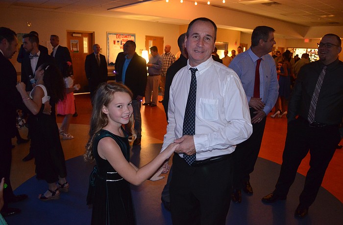 Addison and Jimmy Gill dance to the music.