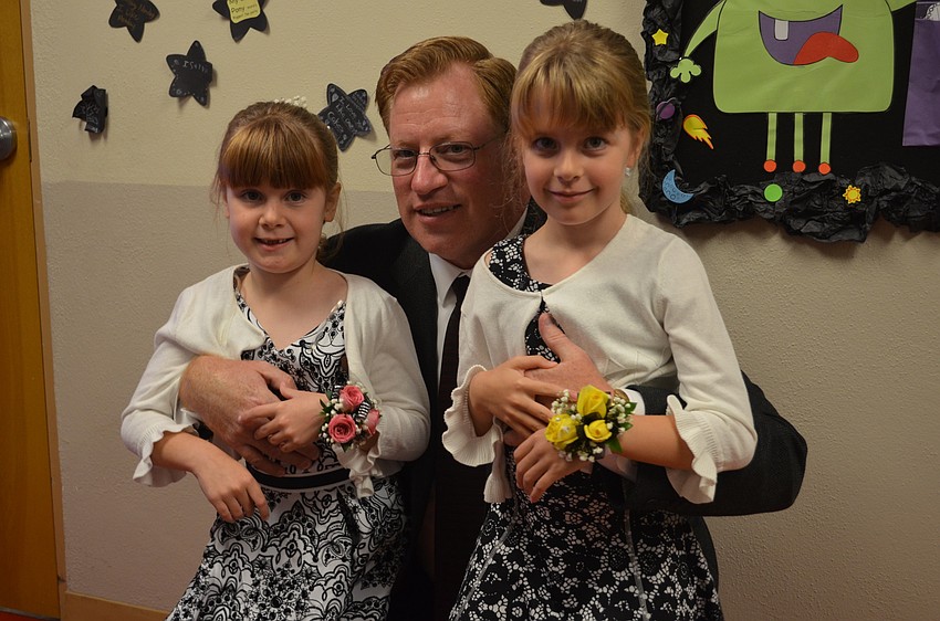 Kimberly and Angela Lavick pose with their father, Chris.