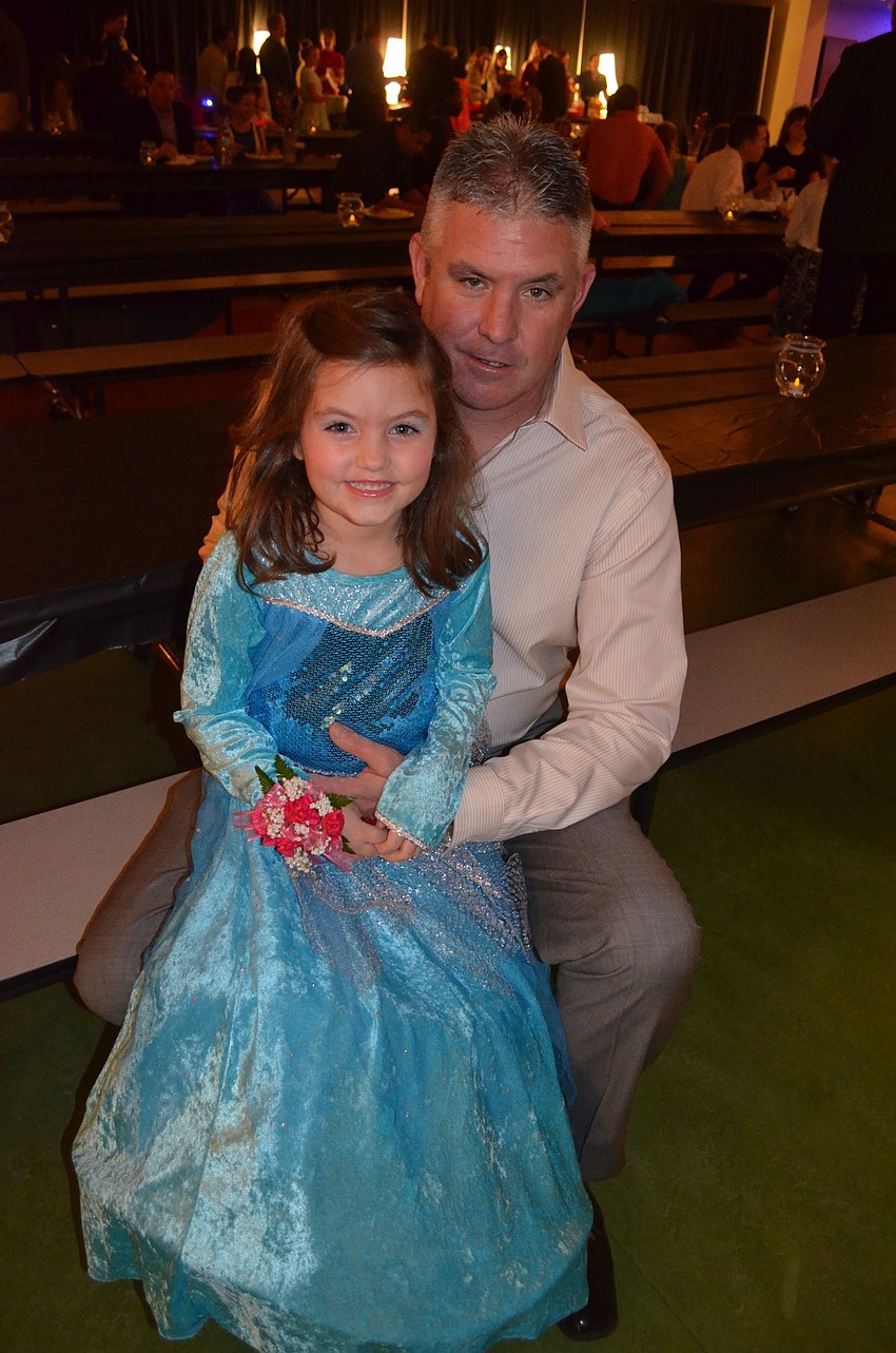 Savannah Hoffman dresses as Elsa while saying cheese beside her father, Steve.