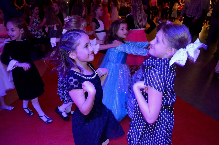Nina Fitzgerald and Cora Augustine make funny faces while dancing with each other.
