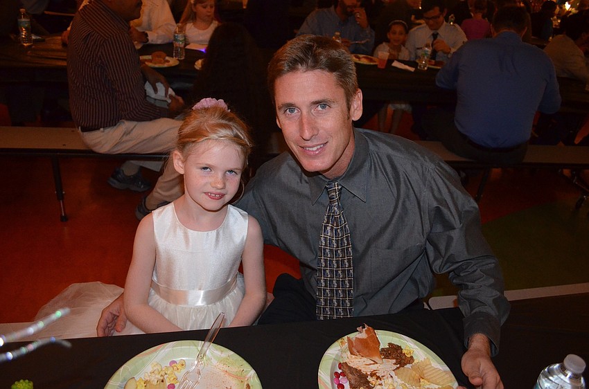 Amelia and Brian Cooper take a break from dancing to enjoy dinner.
