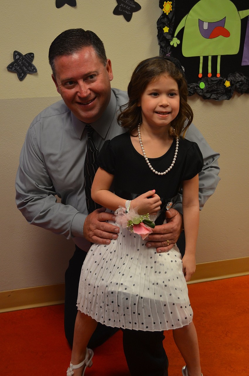 Bill and Ashlyn McBride pose for a photo opp. when they arrive at the ball.