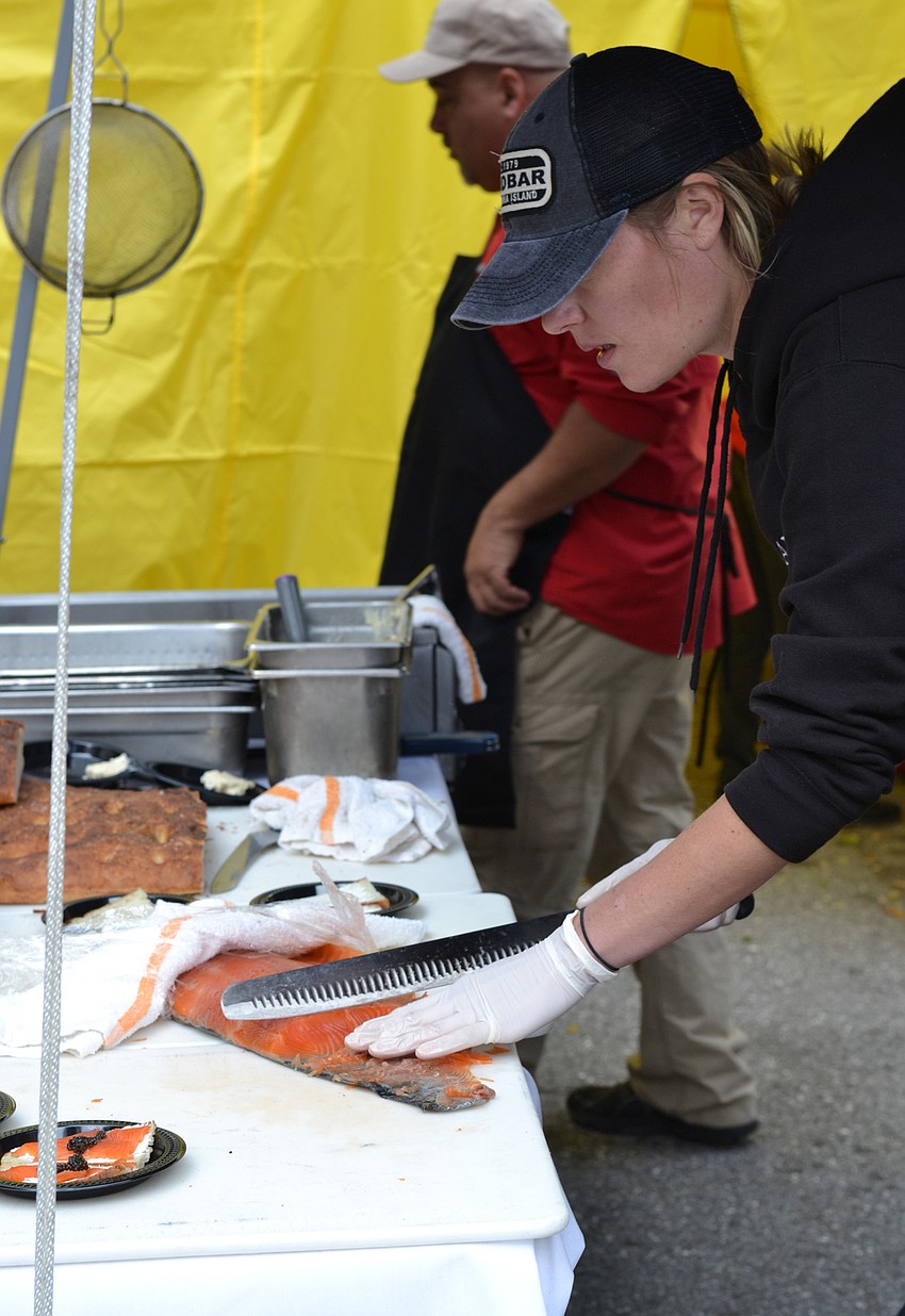 Ariel Michaels from The Beach House slices salmon.