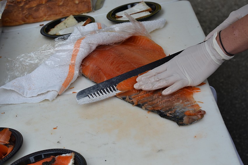 Ariel Michaels slices salmon.