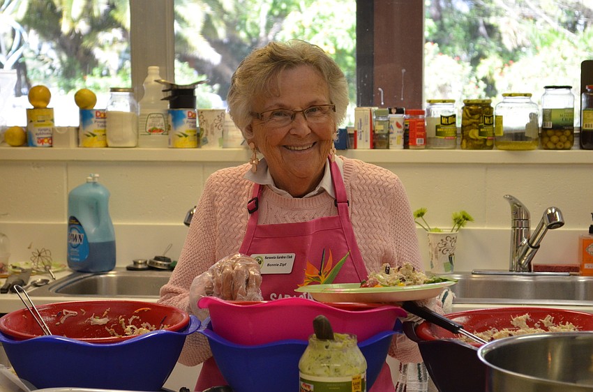 Bonnie Zipf helps prepare snacks during the annual flower show.