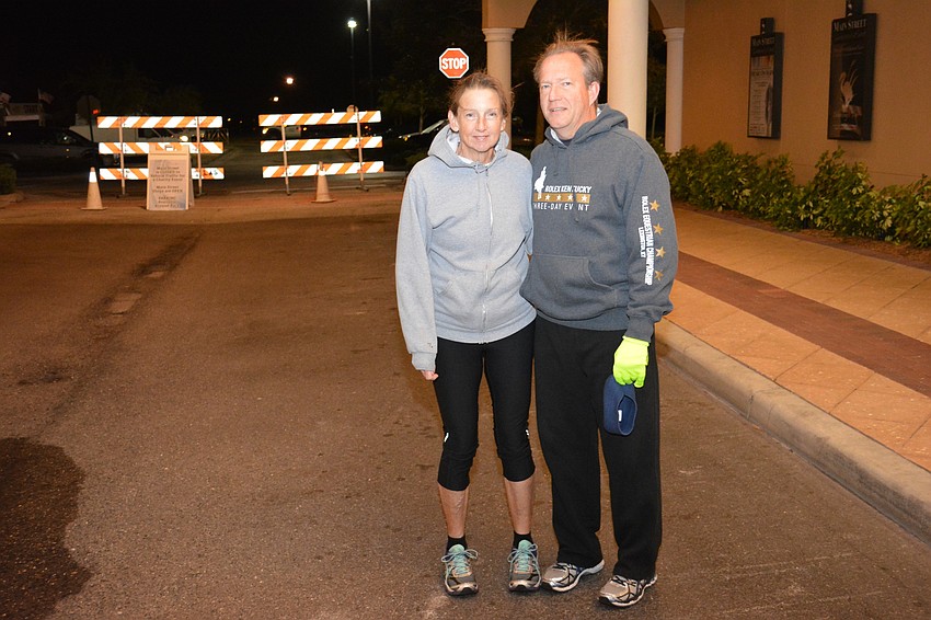 Sarasota's Steve Crane and Betsie Van Vyven try to stay warm before the race. Crane is the Booker High School track coach so his athletes had a chance to evaluate his running style.