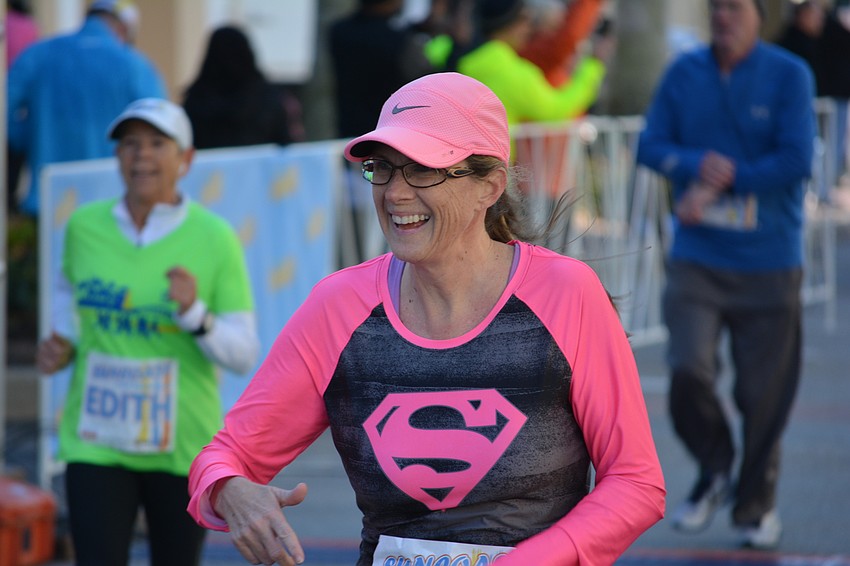 Beth Waskom of Sarasota is all smiles as she crosses the finish line. 