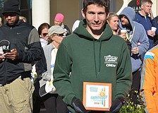 Overall champion Michael Lamb of Bradenton poses with his plaque. Lamb, a University of South Florida student, set a personal best at 1:14.32.