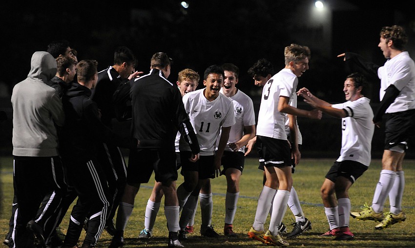 Pablo Vargas, No. 11, and his teammates celebrate following his second goal of the game.