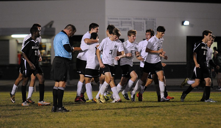 The Lakewood Ranch High boys soccer team celebrates following junior midfielder Tyler Puhalovich's game-tying goal in the second half.