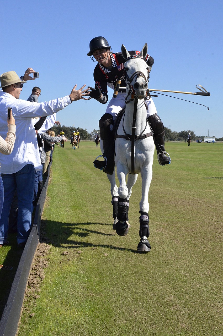 Alec McCain of Bradenton gets a high five from Southside Polo player, Buck Schott.
