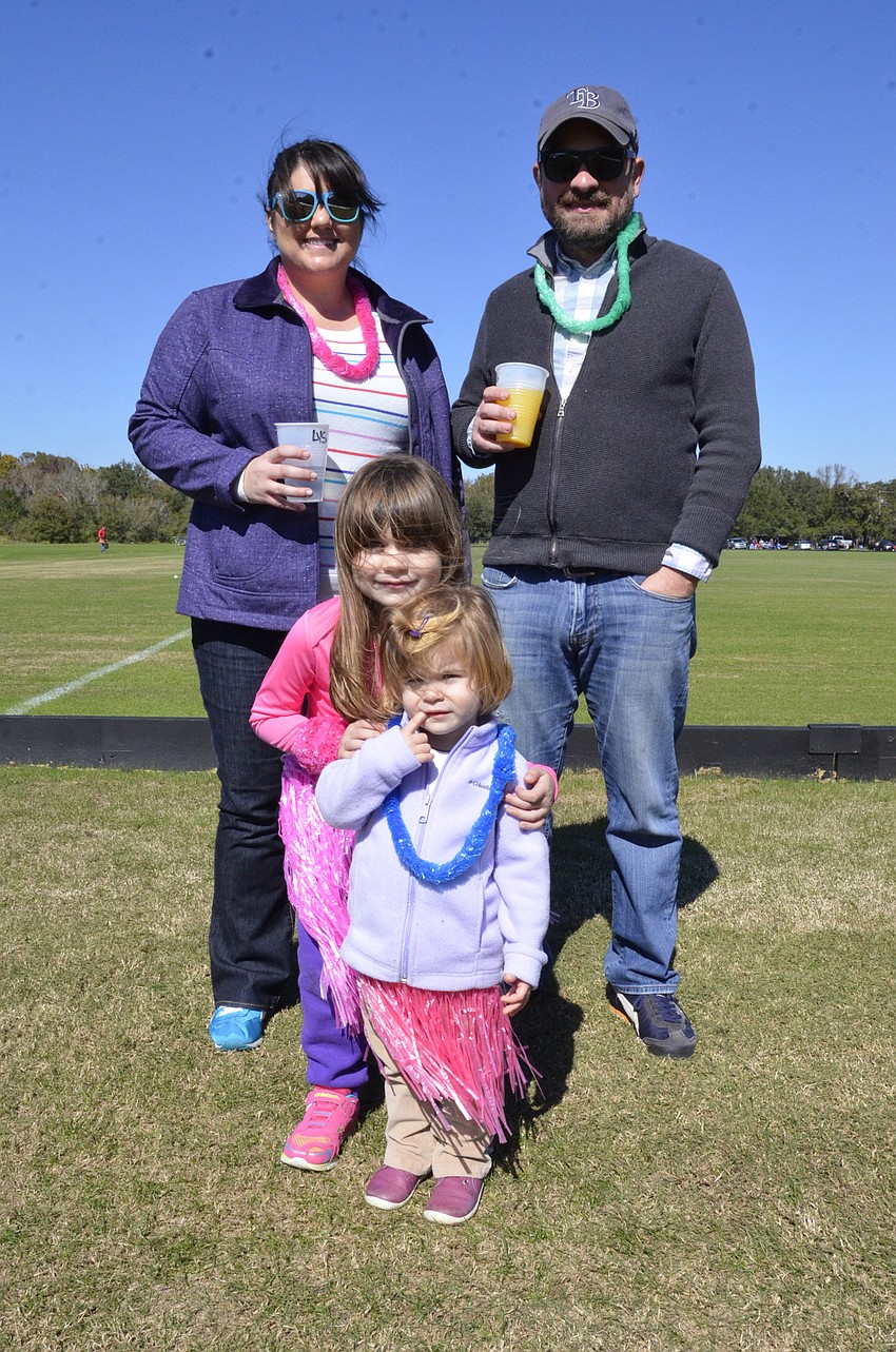 Alyssa, Eugene and Emma Cappelluti of Bradenton and their niece, Leigh McEachron sport tropical leis at the tailgate.