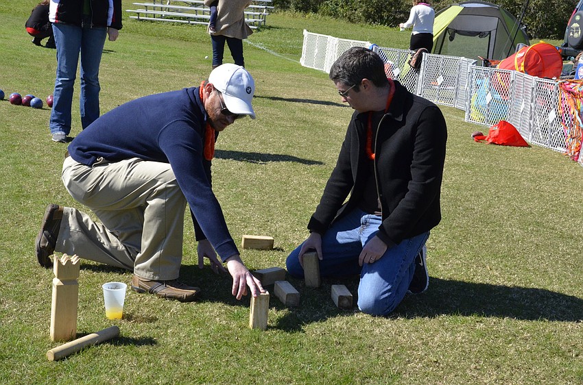 Chris Lindhardt of St. Petersburg and Joe Steele of Clearwater stack their blocks during a game of Kubb.