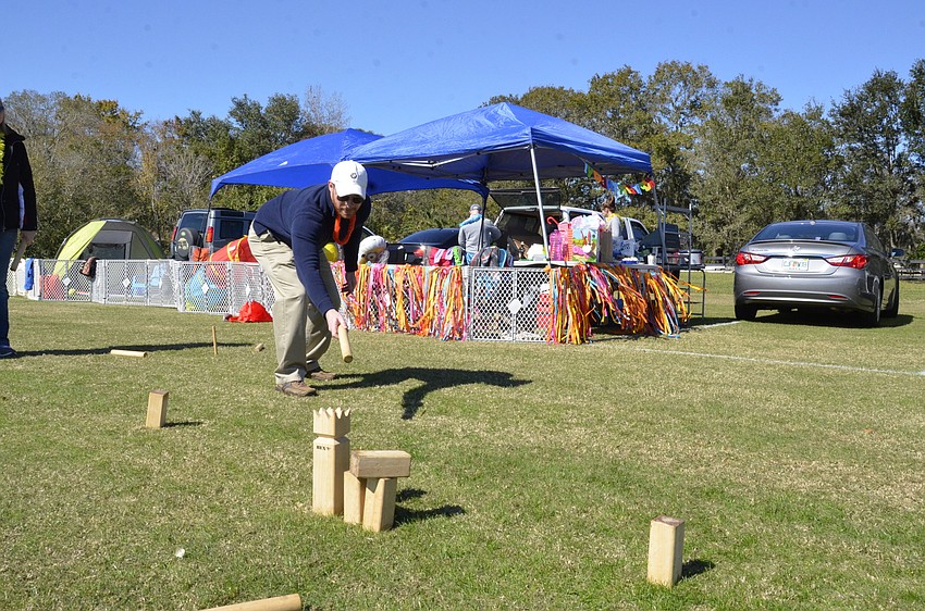 Chris Lindhardt of St. Petersburg tries to knock over a block, without usurping the castle, during a game of Kubb.