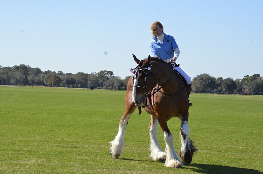 Dana Aschinger of Lexington, Ken., and Burt prepare to carry the flag on the field before the match.