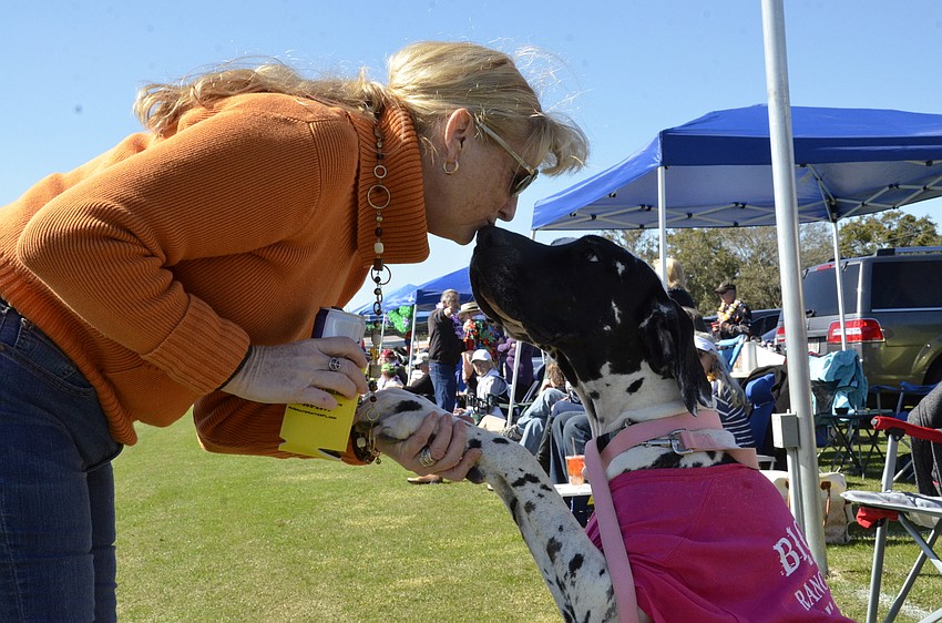 Melanie Lehmann of Sarasota gives Squirrel the Great Dane from Big Dog Ranch Rescue a kiss for good behavior.