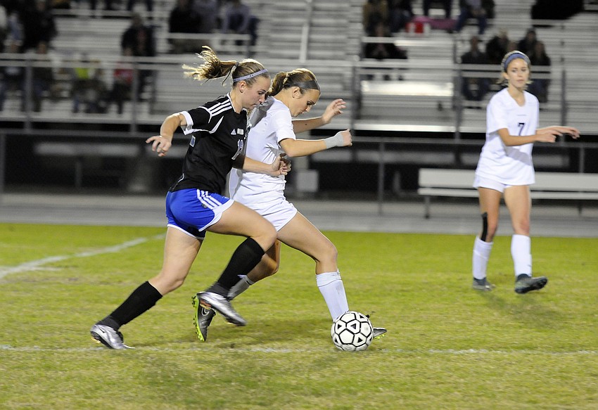 Braden River's Erin McGrath  attempts to push the ball past Ida Baker's Haley Rounsifer.