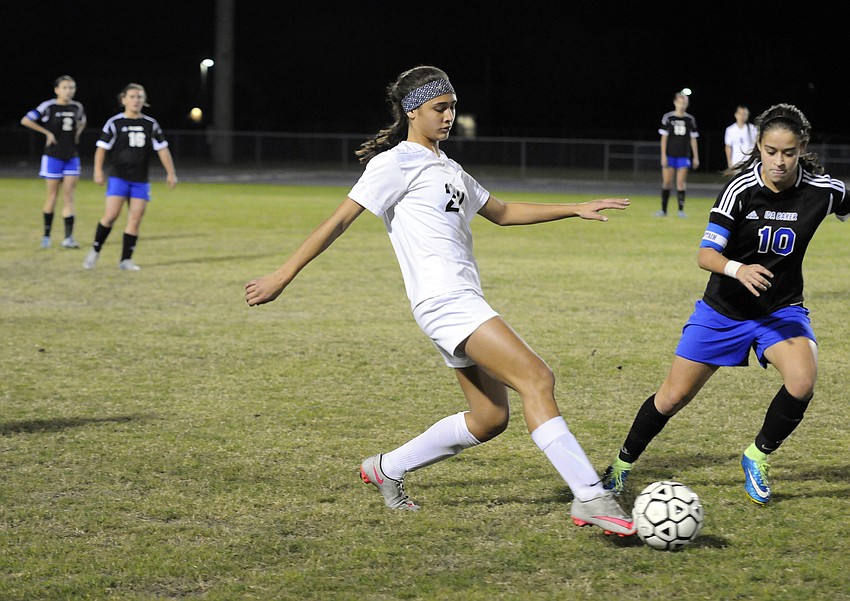 Braden River freshman Savanah Decastro sends the ball past Ida Baker's Marcela Montoya.