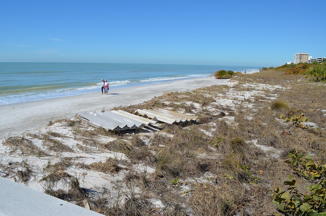 The remaining dunes and vegetation that serves as the last line of shoreline defense for Lâ€™Ambiance and other nearby condominiums, pictured on Monday, after a strong cold front.