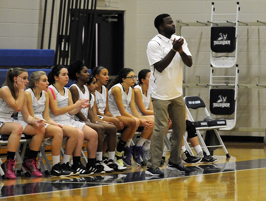 Coach Jamie Roberts and the rest of the ODA girls basketball team look on from the bench in the first half.
